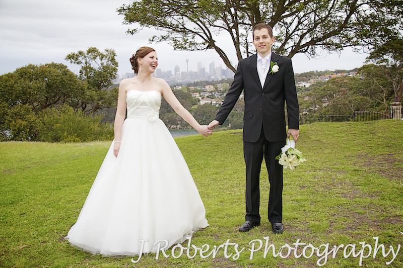 Bride and groom smiling at each other holding hands - wedding photography sydney